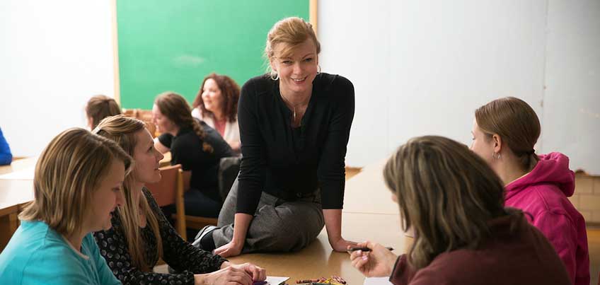 Community Health professor speaking to students in a classroom